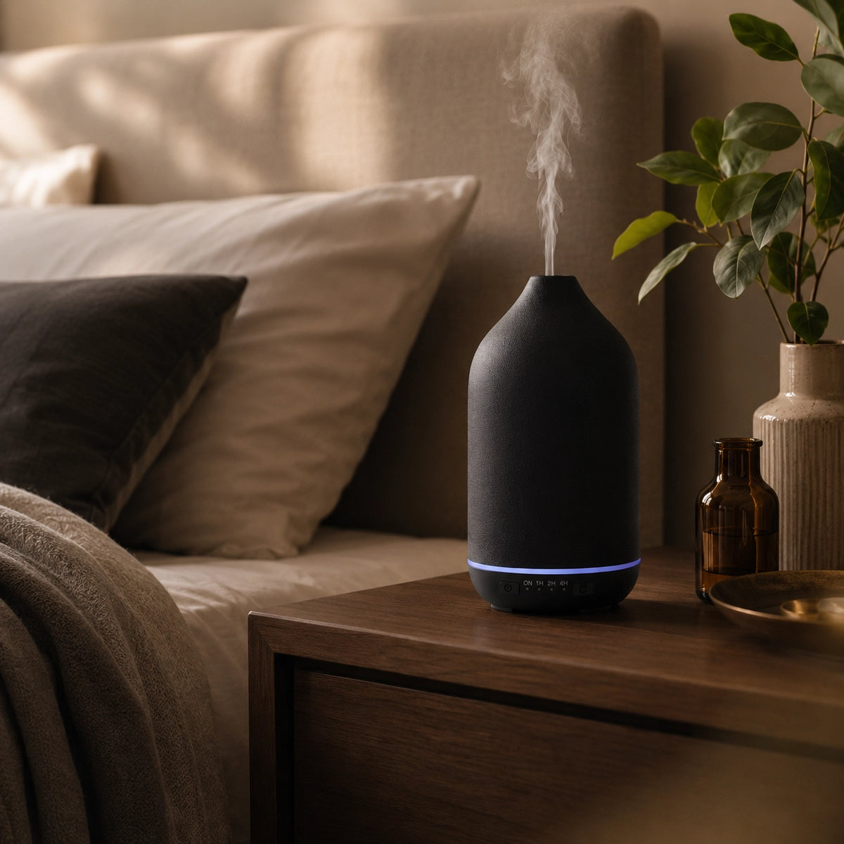 Quiet black ceramic essential oil diffuser releasing cool mist